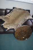 Leopard Skin Rug and an Ethnic Carved Wooden Tabletop