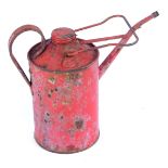 A red vintage oil can.