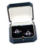A pair of silver Aston Martin cuff links, each bearing the Austin Martin badge and logo engraving,
