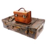 A vintage brown leather suitcase, 81cm wide, and a tan leather bowls bag. (2)