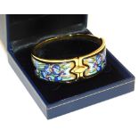 A Michaela Frey of Wien enamel set bangle, in yellow metal, decorated in the Art Nouveau style with