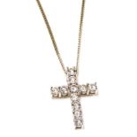 An 18ct white gold and diamond cross pendant, set with eleven diamonds, approx 1/3cts, on a fine cur