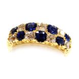 A sapphire and diamond two row ring, each stone set at intervals, in yellow metal, diamonds approx 0