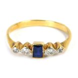 A sapphire and diamond dress ring, the central rectangular cut sapphire in rub over setting, flanked