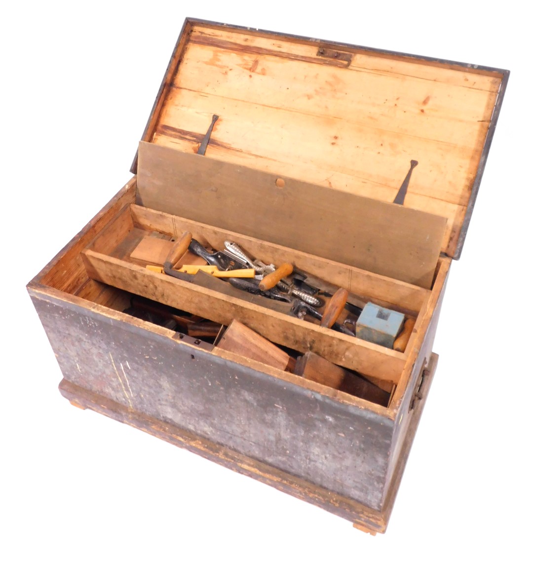 A stained pine carpenter's tool chest, containing moulding planes, braces, saws and other tools, che