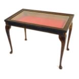 An oak display table, with tilt top a red baize lined interior, on cabriole legs, 53cm high, 78cm wi