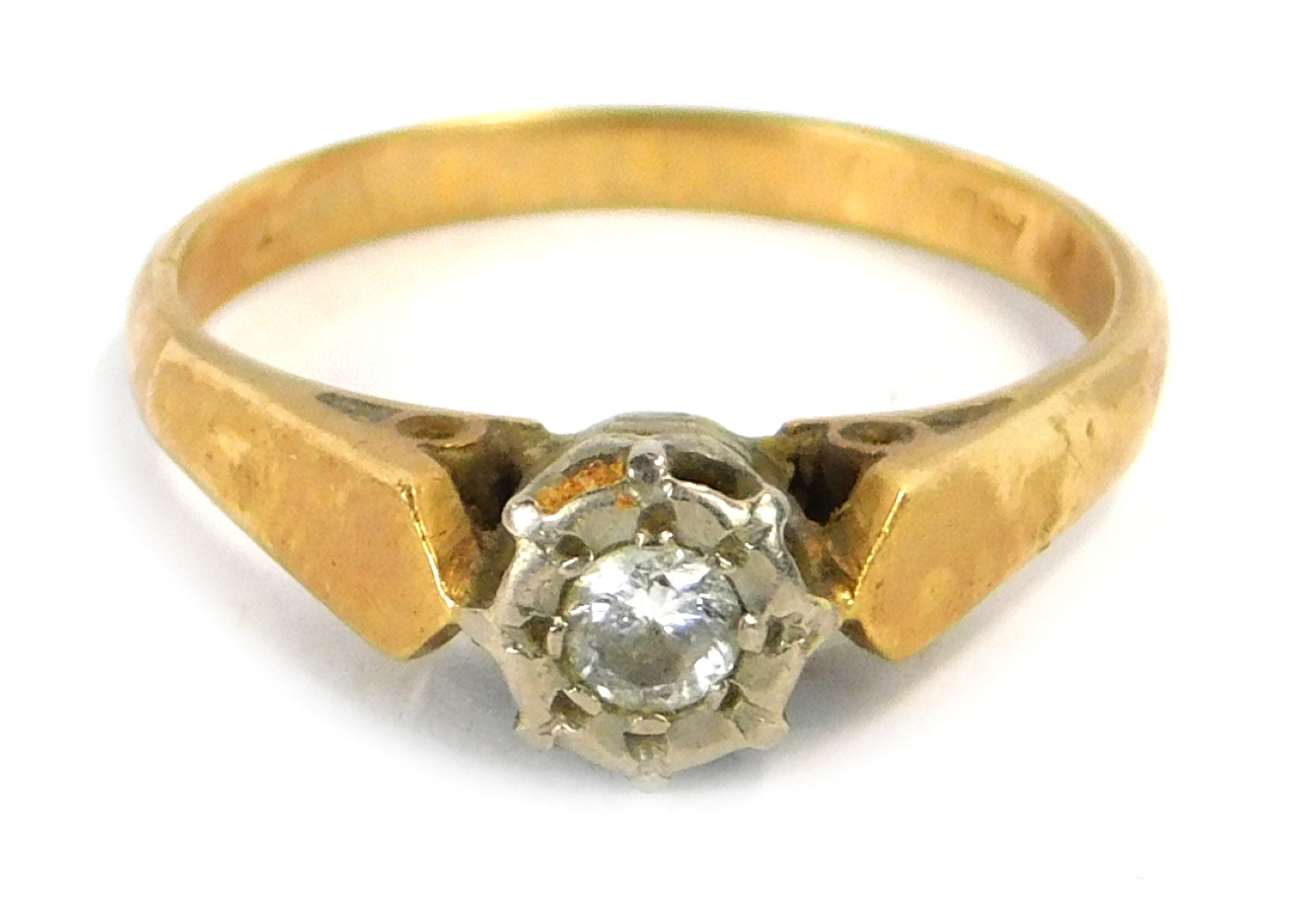 A diamond dress ring, set with single illusion set tiny diamond, in a white gold setting, on a yello