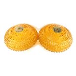 Two 1960s/70s orange moulded glass light shades, each with a brass fan cap support, 30cm diameter.