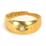 An 18ct gold diamond solitaire ring, the tiny diamond in illusion star setting, ring size L, 2.2g al