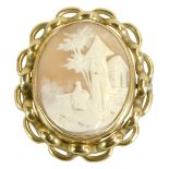 A late 19thC shell cameo brooch, depicting maiden with outbuildings, in a pleated silver plated fram