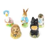 Five Beatrix potter figures, comprising Jemima Puddle-Duck, Miss Moppet, and Peter Rabbit, gold back