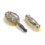 A George V Art Nouveau style silver backed hair brush and clothes brush, embossed with orchids and g
