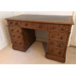 A Victorian oak twin pedestal desk, with inset gilt leather skiver top, three drawers to the frieze