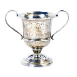 A George VI silver trophy cup, with two looped handled on a stepped foot,