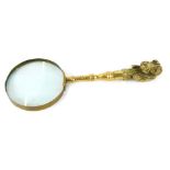 A brass handled magnifying glass, cast with a head of a basset hound, 33cm wide.