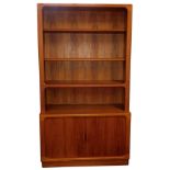 A Danish Glostrup Mobelfabrik teak cupboard bookcase, with three shelves, above a pair of tambour fr