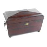 A Regency mahogany sarcophagus shaped tea caddy, with ring handles, the hinged lid opening to reveal