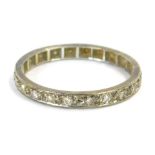 An eternity ring, set with white stones, in a white metal frame, unmarked, ring size Q½, 1.7g all in