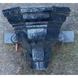 A black painted metal drain hopper.