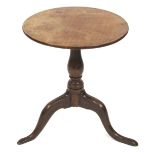 A George III mahogany occasional table, with a circular top raised on a baluster turned column over