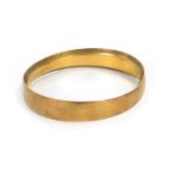 A 22ct gold wedding band, of hammered plain design, ring size O, 2.4g, misshapen.