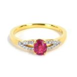 A ruby and diamond dress ring, with oval cut ruby in four claw raised basket setting, with V splayed