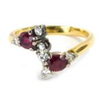 A ruby and diamond dress ring, set with two oval cut rubies, and six round brilliant cut diamonds, e