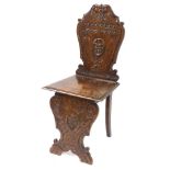 A late 19thC Continental oak Savanarola chair, the back with mask and lead carving, solid seat, rais