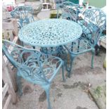A green cast metal circular garden table and four chairs.