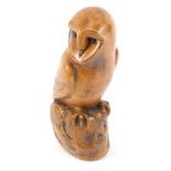 A Wildlife Studio of Hexham carved wooden figure of an owl, modelled perched on a rock, bears paper