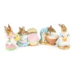 Three Beswick Beatrix potter figures, comprising Anna Maria, Hunca Munca, and Mrs Rabbit, gold back