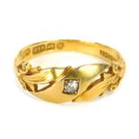 An 18ct gold dress ring, of twist design set with tiny round brilliant cut diamond and fluted should