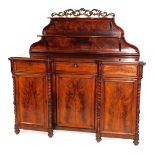 A Victorian flame mahogany inverted breakfront chiffonier, the foliate scroll topped shaped back wit