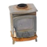 A log burning stove, with grill, 38cm high. (AF)