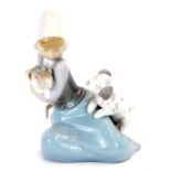 A Lladro porcelain figure of a girl, modelled kneeling with a kitten and a puppy.