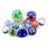 A group of glass paperweights, comprising two marked Caithness, bubble and flower design, large and