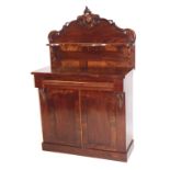 A Victorian mahogany chiffonier, carved shaped back with a single serpentine shelf raised on scroll