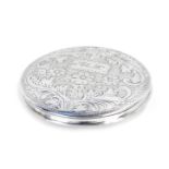 A circular compact, white metal, engraved with flowers and scrolling leaves, rectangular reserve, en