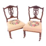 Two Victorian walnut nursing chairs, with tapestry seats. (2)