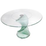 A modern cut glass coffee table, with a circular top, raised on a spiral staircase column over a ste