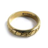 An 18ct gold textured wedding band, size K, 4.3g.