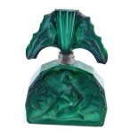 An Art Deco green glass perfume bottle, with Napoleon hat stopper, raised with nude females, the mai