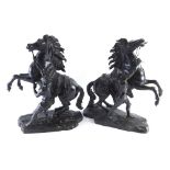 After Coustou. A pair of hollow cast bronze Marly horses, each on rock work bases, signed, 43cm high