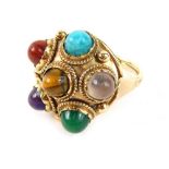 An Eastern inspired multi stone dress ring, of circular form set with turquoise, tigers eye, jade, a