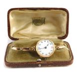 An early 20thC wristwatch, with 3cm diameter Arabic enamel dial in an unmarked 9ct gold case, with e