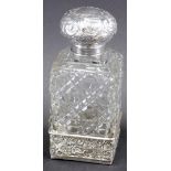 An Edward VII silver and cut glass perfume bottle, with compressed repousse decorated orb stopper, h