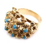 A 14ct gold cluster ring, claw set with eight turquoise on a plain shank, marked 585, size O, 10.7g