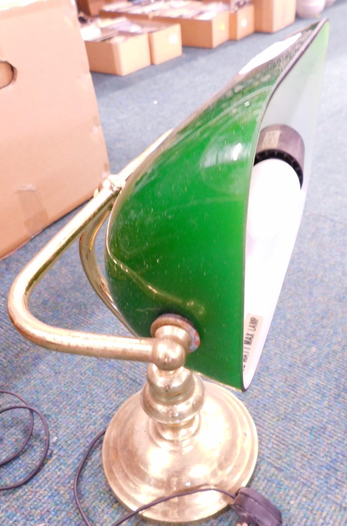A club style desk lamp, with brass articulated stem and green shade.