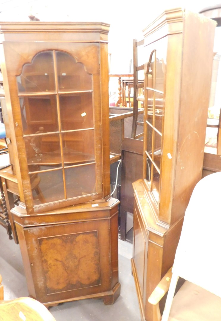 A pair of walnut corner cabinets.