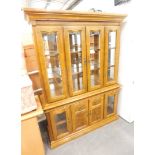 A light oak display cabinet.